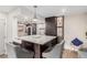 Modern kitchen with a large island, dark wood cabinets, and stainless steel appliances at 8335 Fairmount Dr # 10-208, Denver, CO 80247