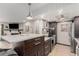 Modern kitchen open to the living room features stainless steel appliances and a large island with seating at 8335 Fairmount Dr # 10-208, Denver, CO 80247