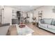 Open-concept living room with a cozy seating area and adjacent modern kitchen and bar at 8335 Fairmount Dr # 10-208, Denver, CO 80247