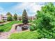 Elevated view of community pond with fountain surrounded by manicured lawns and condo buildings at 8335 Fairmount Dr # 10-208, Denver, CO 80247