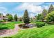 Beautiful community pond with fountain, lush lawns, and well-maintained condominium buildings at 8335 Fairmount Dr # 10-208, Denver, CO 80247