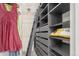 Organized walk-in closet with custom shelving, drawers, ladder and modern design elements at 8335 Fairmount Dr # 10-208, Denver, CO 80247