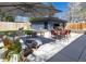 Beautiful backyard with a detached garage, patio, outdoor seating, dining area, and lush landscaping at 1321 S Edison Way, Denver, CO 80222