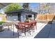 Spacious backyard with a detached garage, patio, outdoor dining area, seating, and landscaping at 1321 S Edison Way, Denver, CO 80222