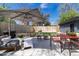 Backyard with a large patio, outdoor seating, dining area, privacy fence, and landscaping at 1321 S Edison Way, Denver, CO 80222