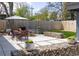 An outdoor patio with dining table, chairs, and a privacy fence create a backyard space perfect for relaxing at 1321 S Edison Way, Denver, CO 80222