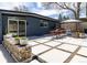 Modern backyard patio with a dining table, chairs, landscaping, and a privacy fence make this a great outdoor space at 1321 S Edison Way, Denver, CO 80222