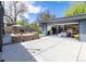 The backyard features a modern patio, outdoor dining, stylish landscaping, and converted garage for flexible living at 1321 S Edison Way, Denver, CO 80222