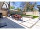 Spacious backyard featuring a concrete patio, outdoor dining area, manicured lawn, and privacy fence at 1321 S Edison Way, Denver, CO 80222