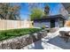 Inviting backyard featuring a lush lawn, detached garage, stone accents, and patio area at 1321 S Edison Way, Denver, CO 80222