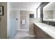 Sleek bathroom featuring a glass enclosed shower, floating vanity, and geometric wallpaper at 1321 S Edison Way, Denver, CO 80222