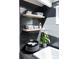 Cozy bathroom with dark tile, floating shelves, and decorative accents at 1321 S Edison Way, Denver, CO 80222