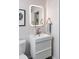 A well-lit, modern bathroom features a sleek vanity with stylish mirror and contemporary fixtures at 1321 S Edison Way, Denver, CO 80222