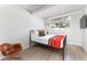 Comfortable bedroom featuring hardwood floors, white walls, and a metal bed frame at 1321 S Edison Way, Denver, CO 80222
