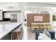 Open-concept dining area with modern lighting, a long table, and seating for eight at 1321 S Edison Way, Denver, CO 80222