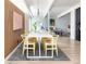 Stylish dining room with a modern light fixture, wood accent wall, and seating for eight guests at 1321 S Edison Way, Denver, CO 80222
