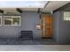 Inviting front entrance featuring a stylish wood door, modern hardware, and contemporary bench at 1321 S Edison Way, Denver, CO 80222