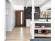 Inviting entryway with wood floors, a stylish front door, and a view into the modern kitchen at 1321 S Edison Way, Denver, CO 80222