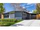 Charming single-story home with a gray exterior, well-manicured lawn, and a paved driveway at 1321 S Edison Way, Denver, CO 80222