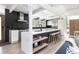 Bright, modern kitchen features an island with bar seating, sleek appliances, and lots of space at 1321 S Edison Way, Denver, CO 80222