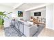 Comfortable living room with a gray sectional, modern art, and lots of natural light at 1321 S Edison Way, Denver, CO 80222
