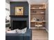 Stylish living room with a modern fireplace, built-in shelving, and a comfortable seating area at 1321 S Edison Way, Denver, CO 80222
