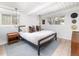 Bright main bedroom featuring hardwood floors, white walls, and a large window at 1321 S Edison Way, Denver, CO 80222