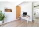 Bright office space featuring hardwood floors, a cork accent wall, and natural lighting at 1321 S Edison Way, Denver, CO 80222
