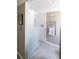 Modern shower with frameless glass enclosure, a towel warmer, and gray tiled floor at 1321 S Edison Way, Denver, CO 80222