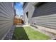 Fenced backyard featuring artifical grass and small patio at 6834 Clay N St, Denver, CO 80221