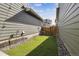 Narrow backyard with low-maintenance turf and rock landscaping at 6834 Clay N St, Denver, CO 80221