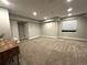 Finished basement offering neutral carpet, ample recessed lighting, and a window providing natural light at 6834 Clay N St, Denver, CO 80221