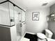 Modern bathroom featuring stylish shower stall and patterned tile floors, and an art piece on the wall at 6834 Clay N St, Denver, CO 80221