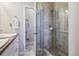 Bright bathroom showing a tiled shower, modern fixtures, and a linen closet at 6834 Clay N St, Denver, CO 80221