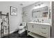 Stylish bathroom featuring sleek black floors, modern fixtures, and a floating vanity at 6834 Clay N St, Denver, CO 80221