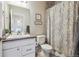 Bathroom with vanity, toilet, and tub with patterned shower curtain at 6834 Clay N St, Denver, CO 80221