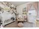 Charming Bedroom with a crib, accent wall, and cozy reading nook at 6834 Clay N St, Denver, CO 80221