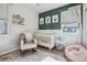Bright Bedroom with a white crib, comfortable chair, and colorful decor at 6834 Clay N St, Denver, CO 80221