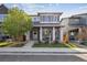Charming two-story home features a covered front porch and well-maintained landscaping at 6834 Clay N St, Denver, CO 80221