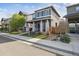 Well-maintained, two-story home with mature landscaping and a 'For Sale' sign in the front yard at 6834 Clay N St, Denver, CO 80221