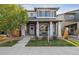 Charming two-story home features a covered front porch and well-maintained landscaping at 6834 Clay N St, Denver, CO 80221