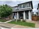 Charming two-story home with a well-maintained lawn and inviting front porch at 6834 Clay N St, Denver, CO 80221