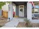 Inviting front porch with swing and wreath on the front door for a warm welcome at 6834 Clay N St, Denver, CO 80221