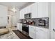 Well-equipped kitchen with granite countertops, modern appliances, and stylish gray backsplash at 6834 Clay N St, Denver, CO 80221
