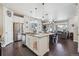 Bright kitchen with stainless steel appliances, granite countertops, and open layout to living space at 6834 Clay N St, Denver, CO 80221