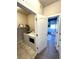 Convenient laundry room with modern washer and dryer next to a carpeted bedroom at 6834 Clay N St, Denver, CO 80221