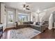 Bright living room featuring hardwood floors, a large sectional sofa, and ample natural light at 6834 Clay N St, Denver, CO 80221