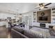 Open-concept living area with hardwood floors and a fireplace, seamlessly connected to the kitchen at 6834 Clay N St, Denver, CO 80221