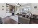 Spacious living room with hardwood floors, built-in shelving, and a large window at 6834 Clay N St, Denver, CO 80221