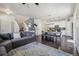 Open-concept living area leading to a well-lit kitchen and dining space at 6834 Clay N St, Denver, CO 80221